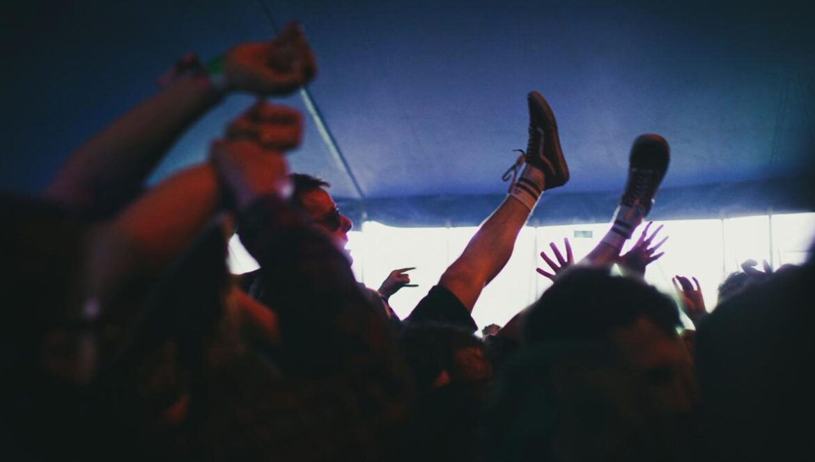 people raising their hands during night time