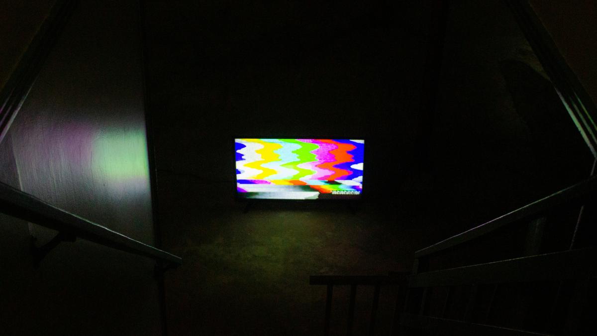 black flat screen tv turned on displaying soccer game