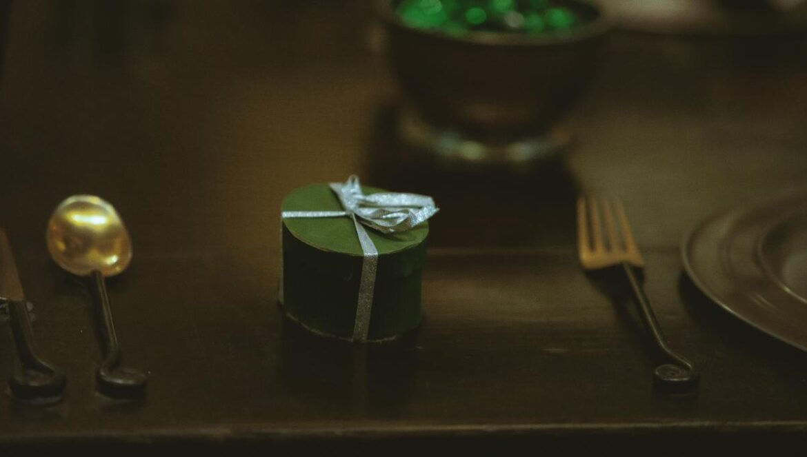silver fork beside green and white box