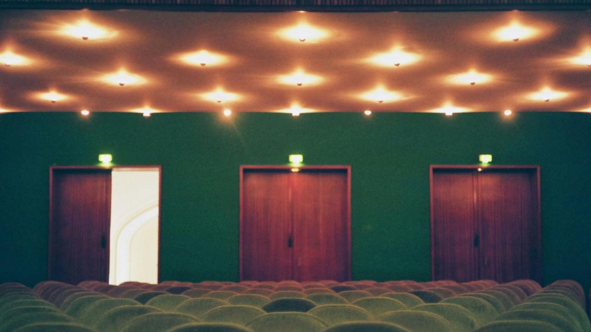 white chairs near red wall