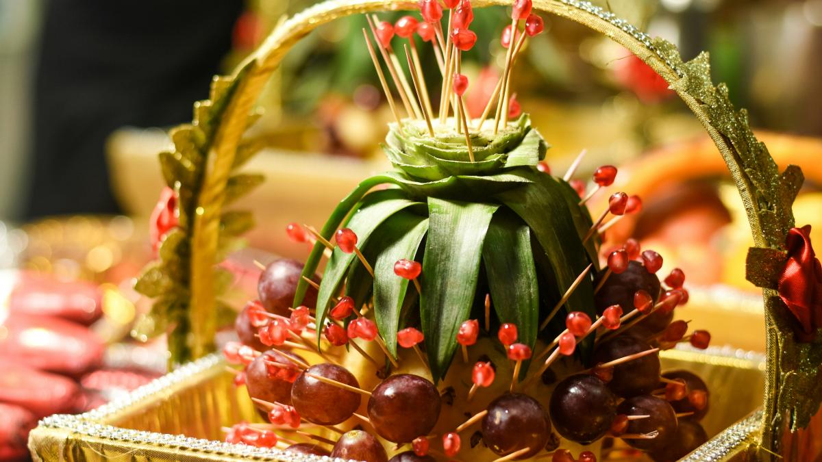 red and green fruit on brown woven basket