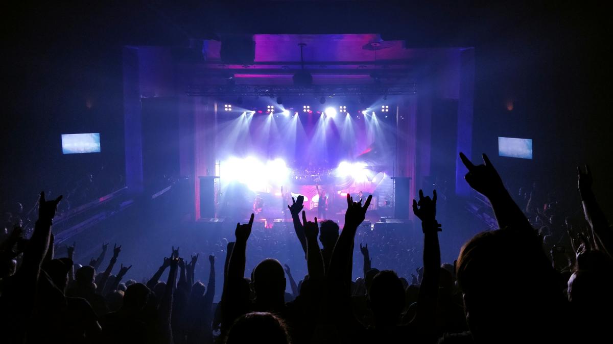 people standing on stage with lights