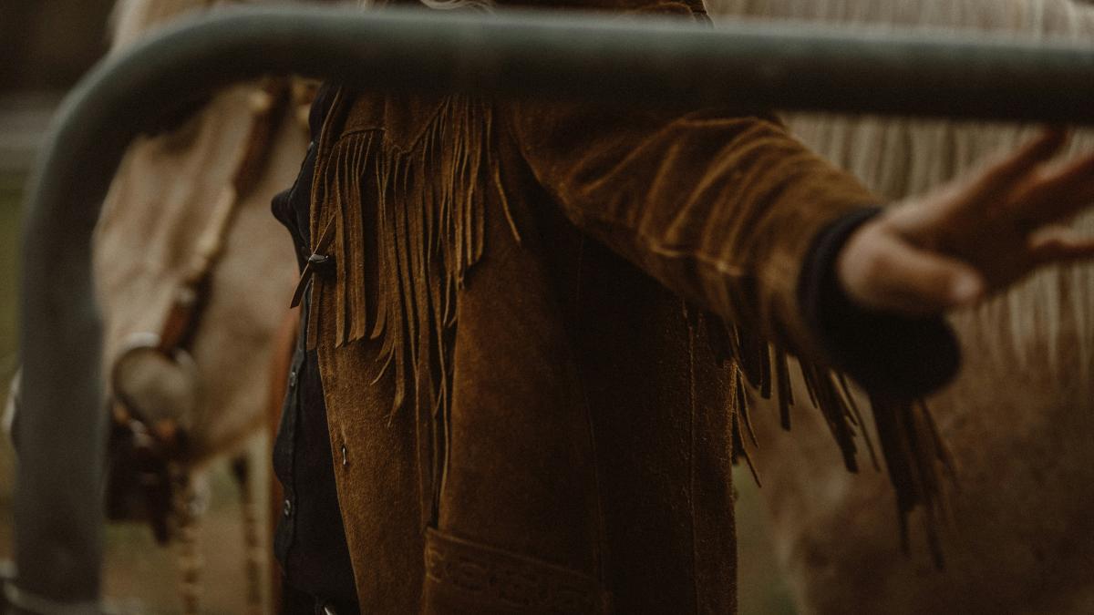 person in brown long sleeve shirt holding brown rope