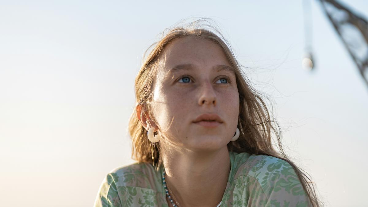 girl in green and white floral shirt
