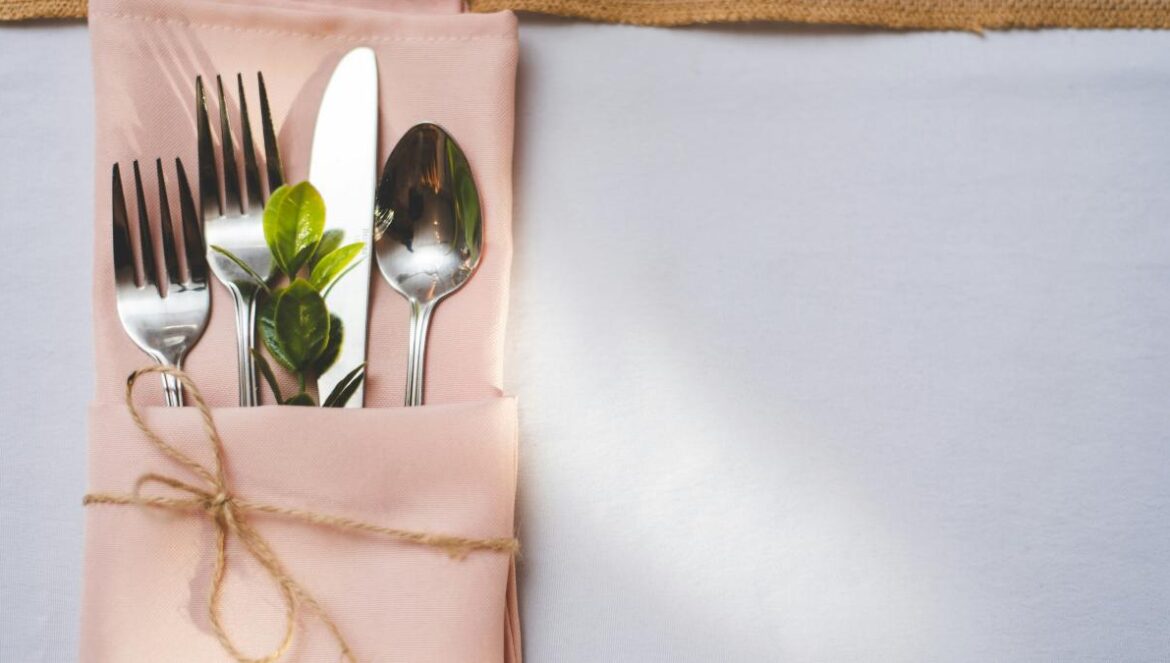silver fork and bread knife on white tissue paper