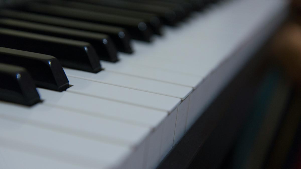 a close up of a black and white piano