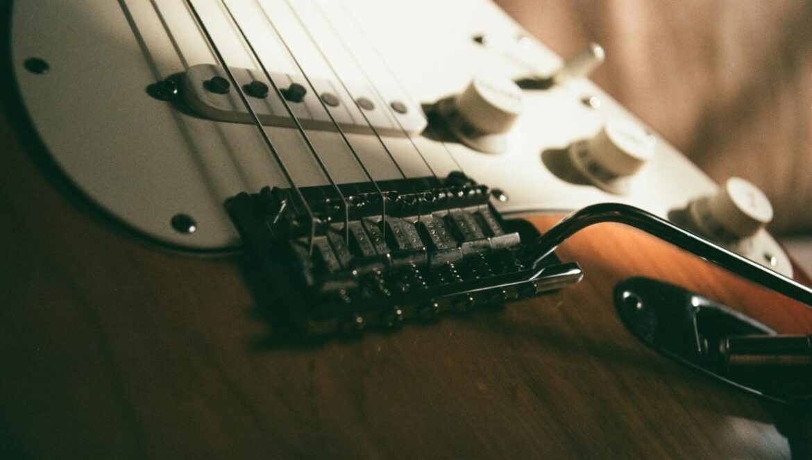 a close up of a guitar and a pair of glasses