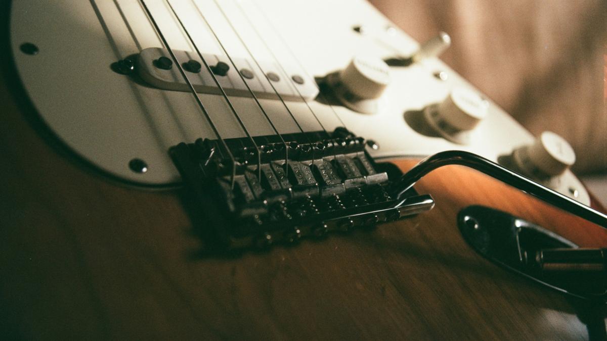 a close up of a guitar and a pair of glasses