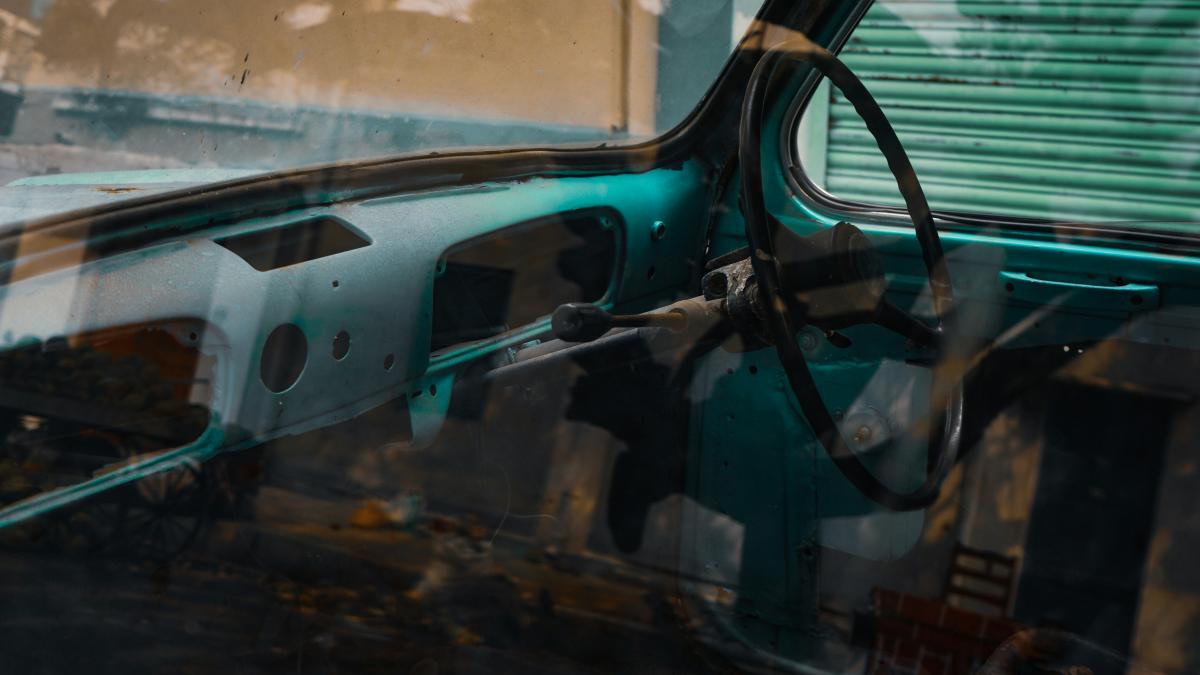 the interior of an old car with the door open