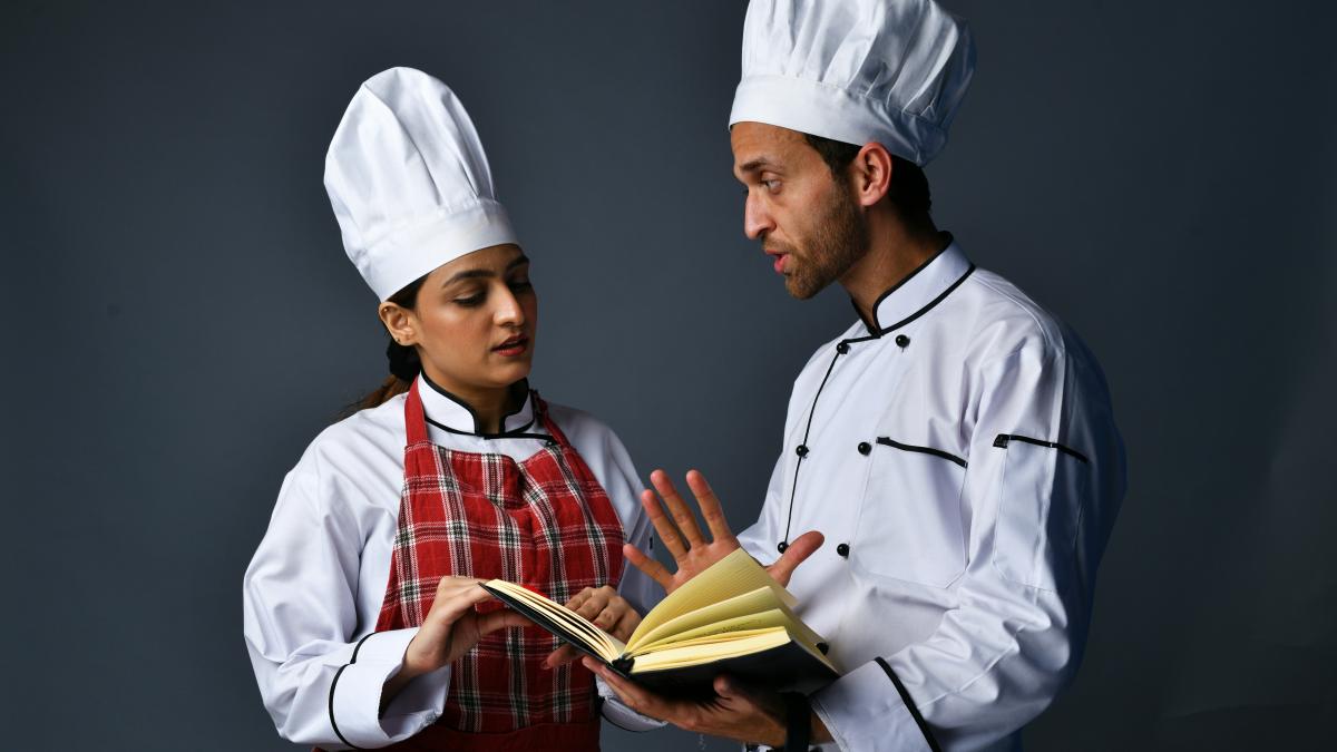 a man and a woman wearing chef outfits