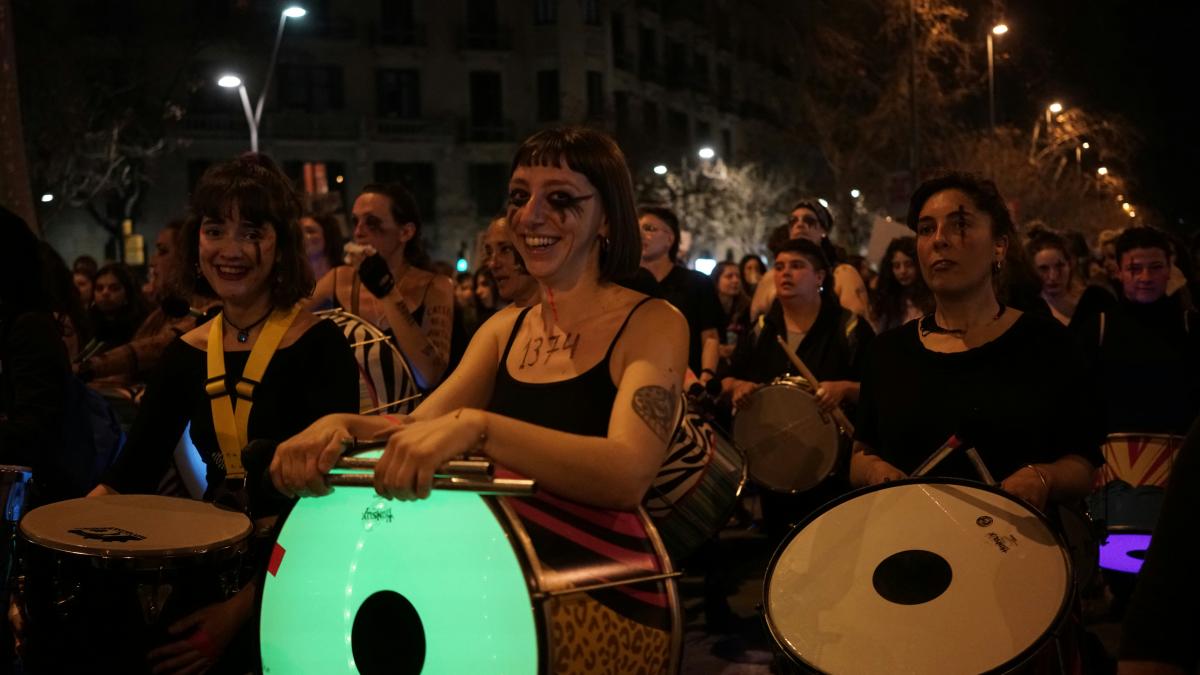 a group of people playing drums in front of a crowd
