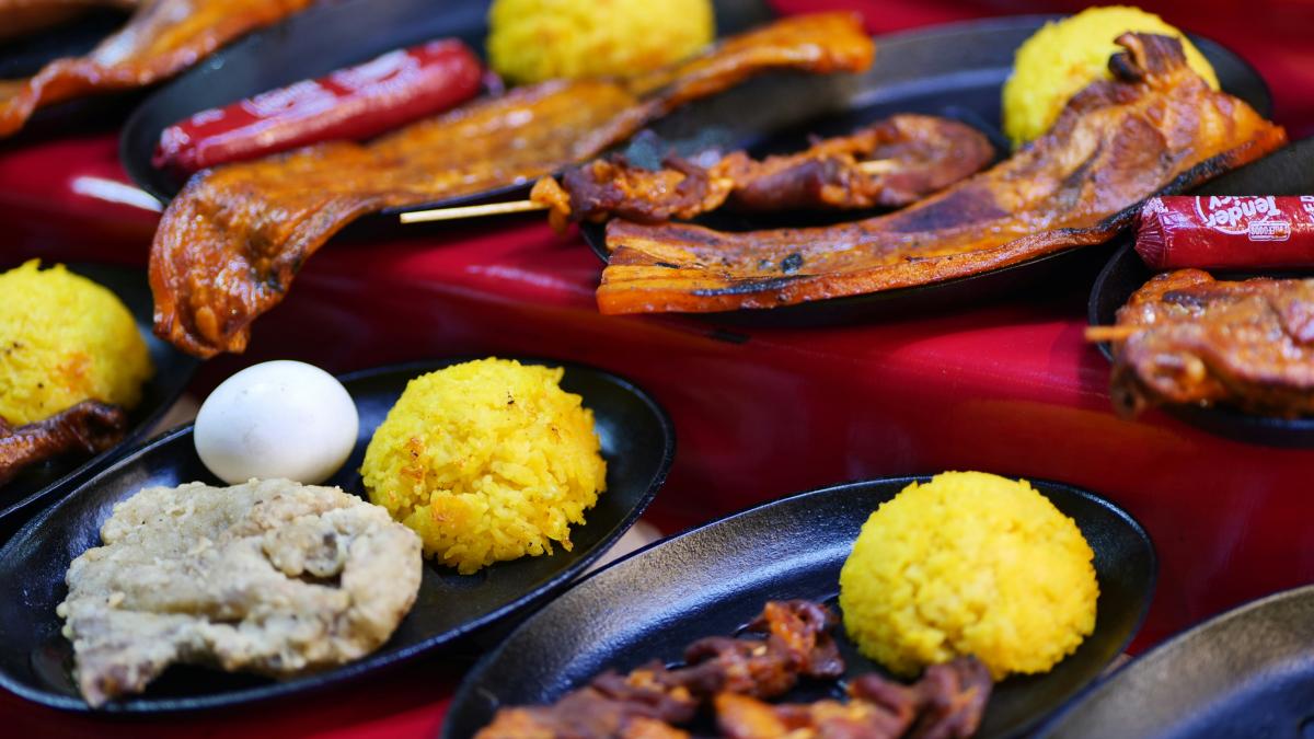 a table topped with black plates filled with food