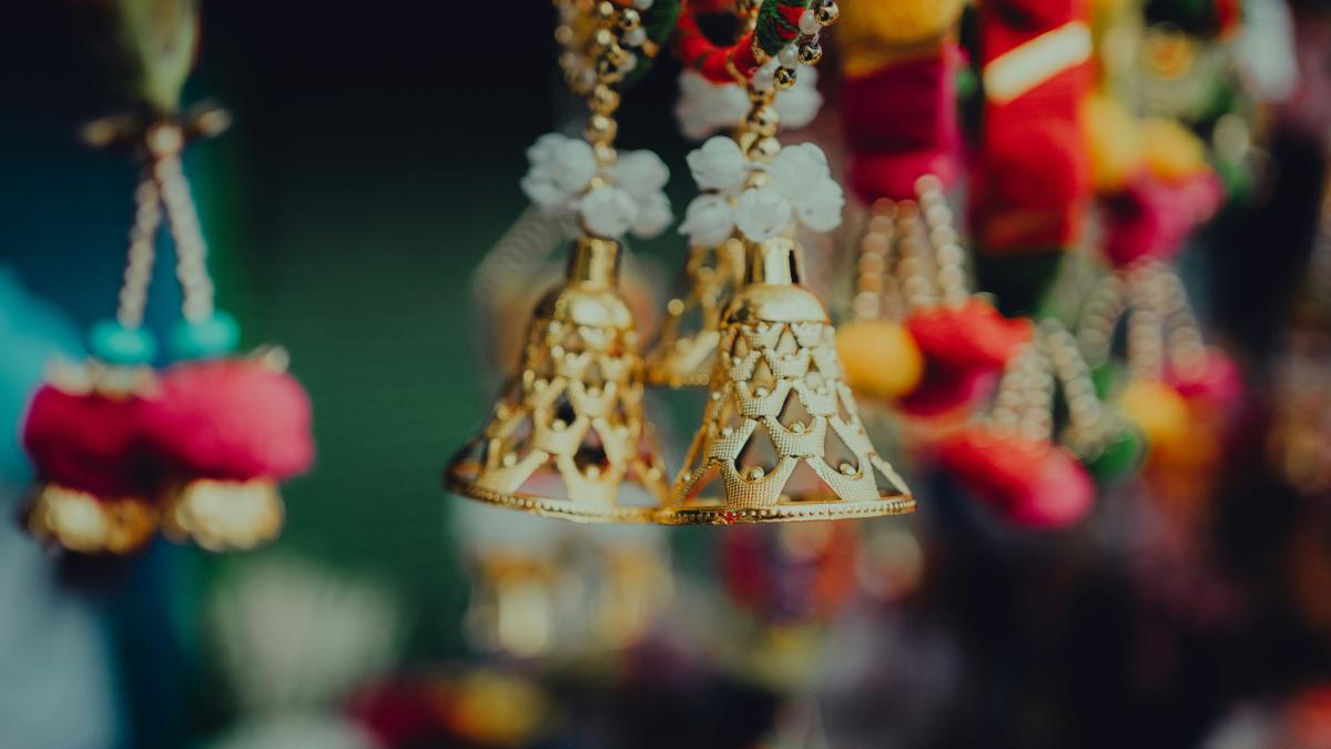 a group of bells hanging from a ceiling