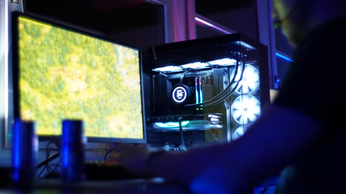 A man sitting in front of a computer monitor