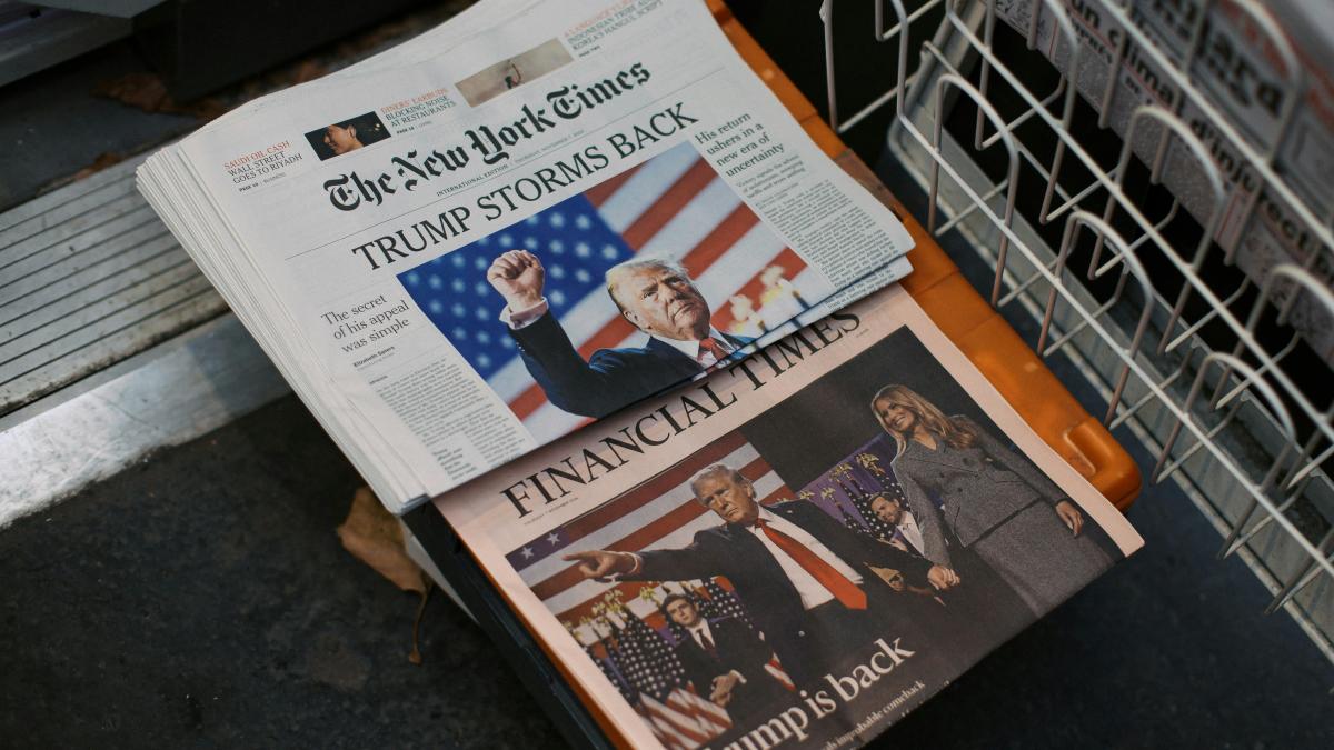 A newspaper sitting on top of a metal dishwasher