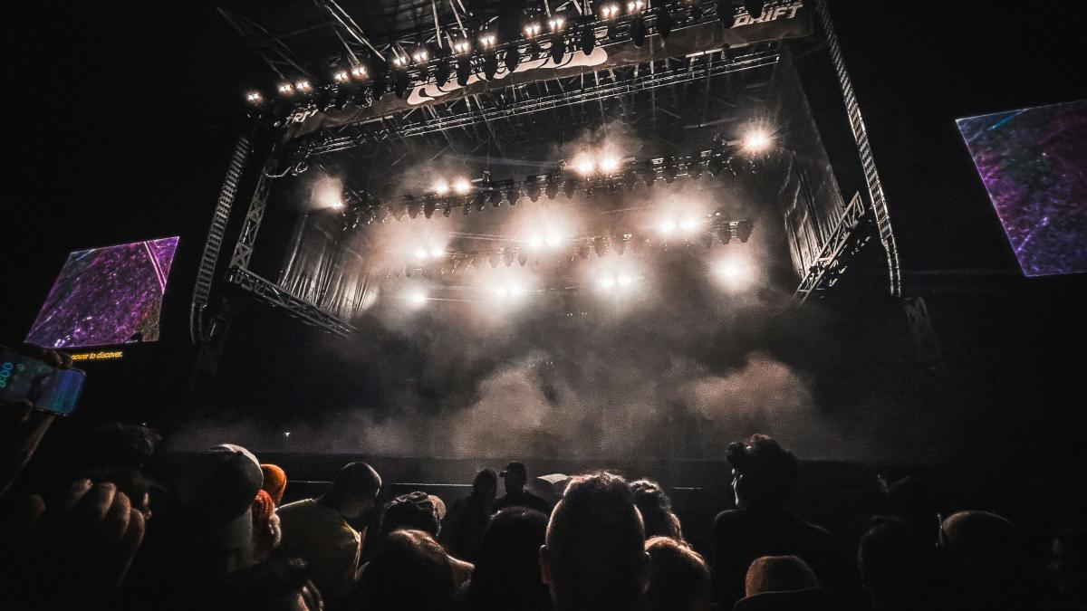 A crowd of people watching a concert on stage