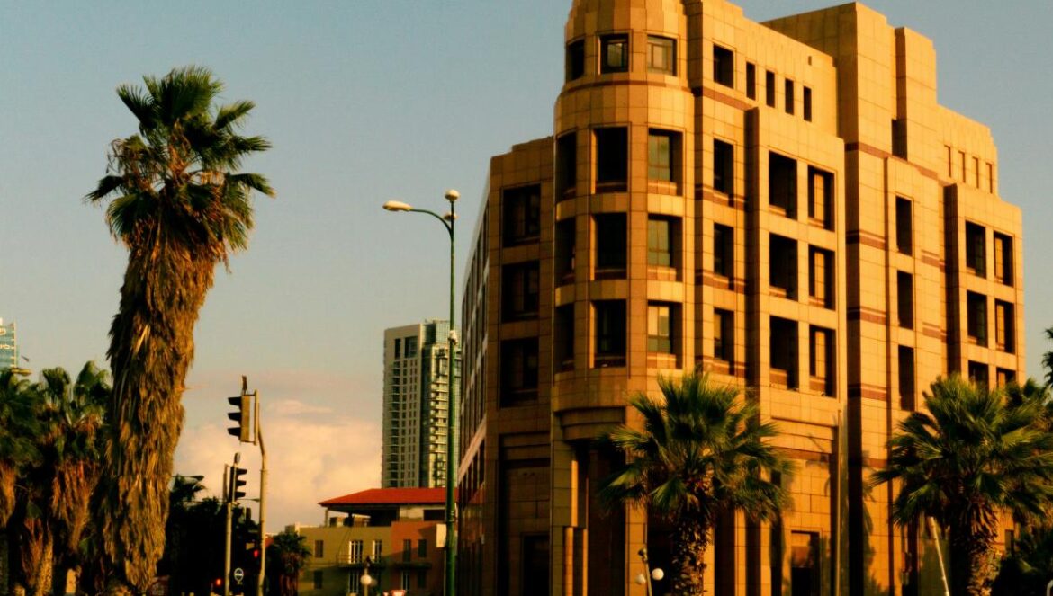 cars parked in front of brown concrete building during daytime