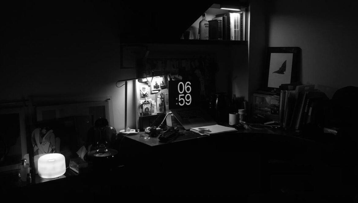 a desk with a lamp and a picture on it