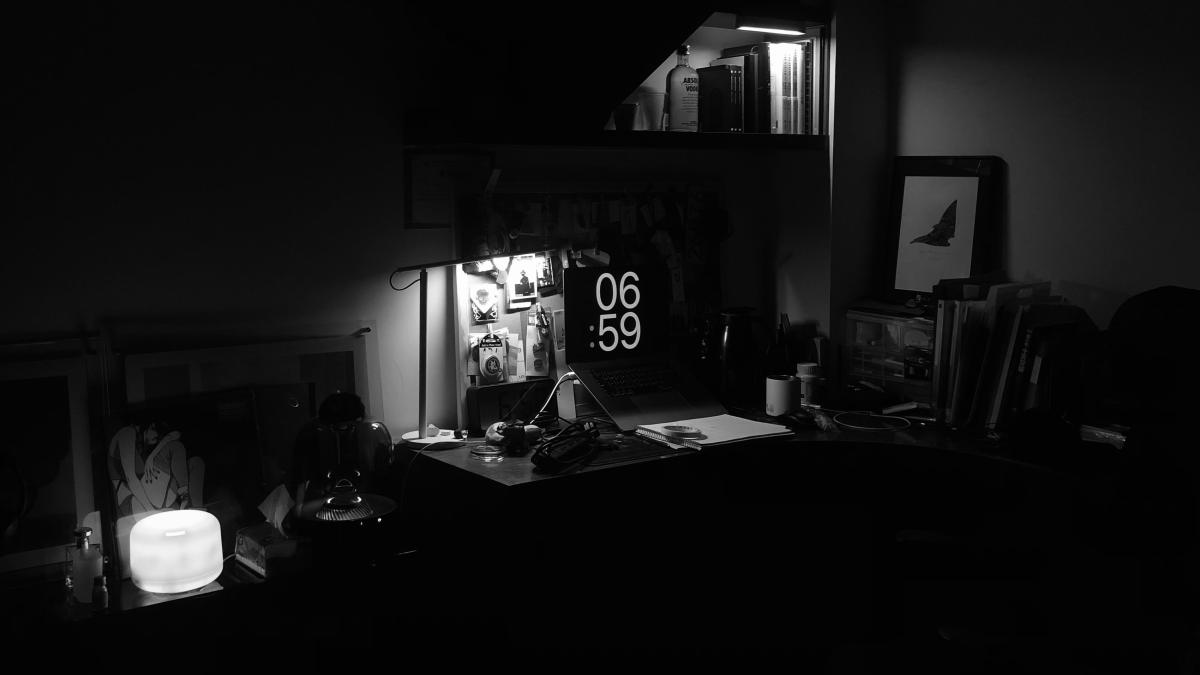 a desk with a lamp and a picture on it