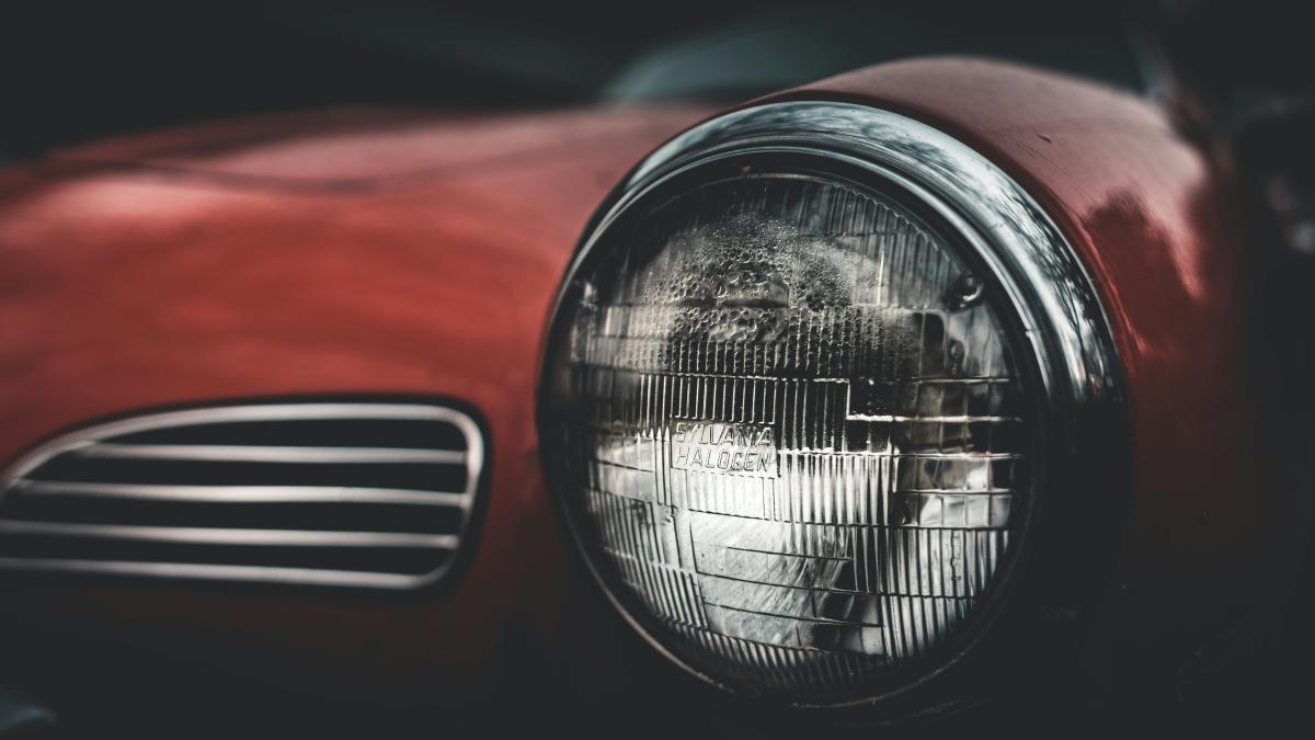 selective focus photography of red car headlight
