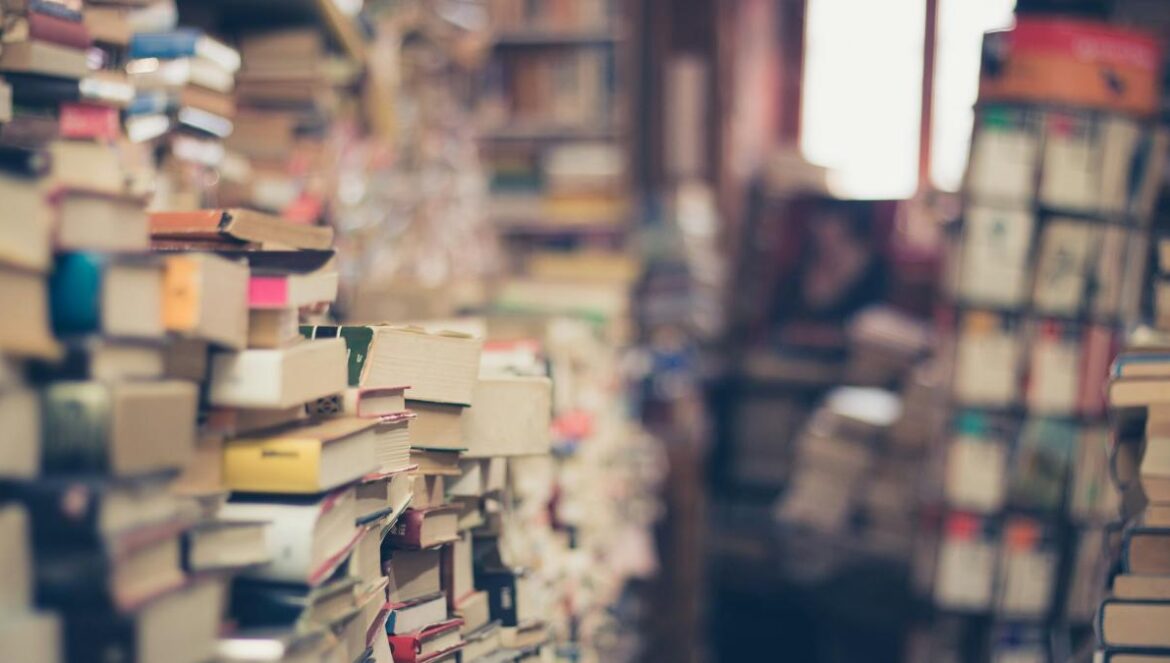 assorted books in shallow focus photography