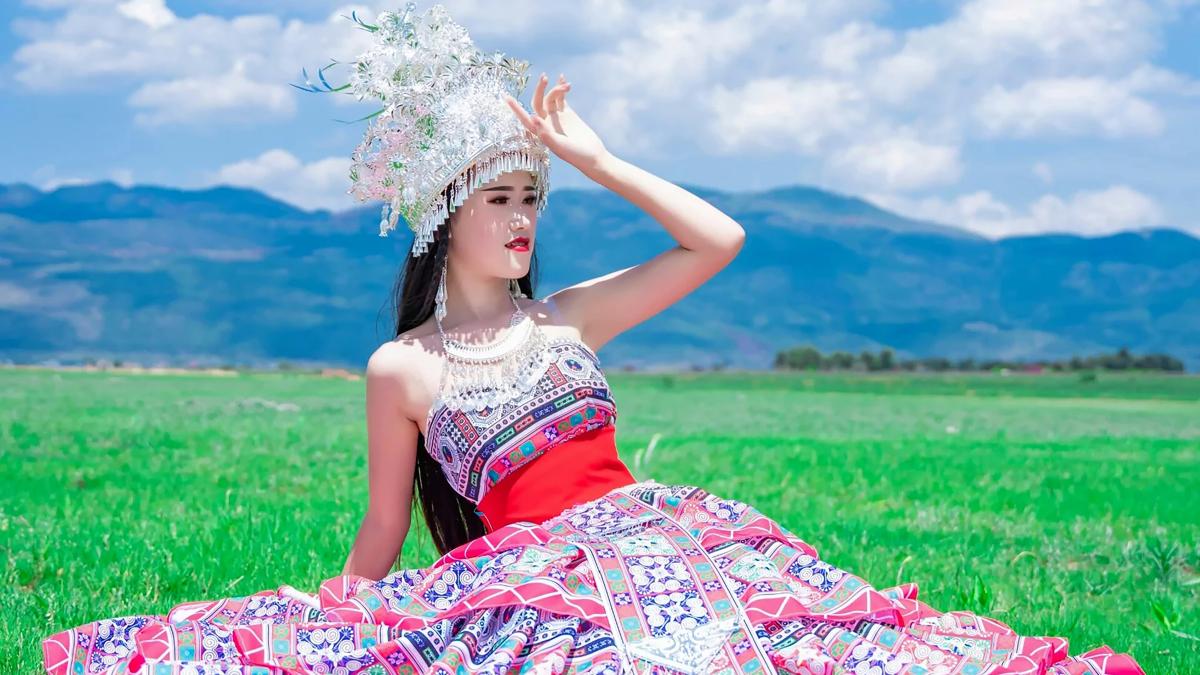 woman in red and white floral tube dress wearing white floral headdress