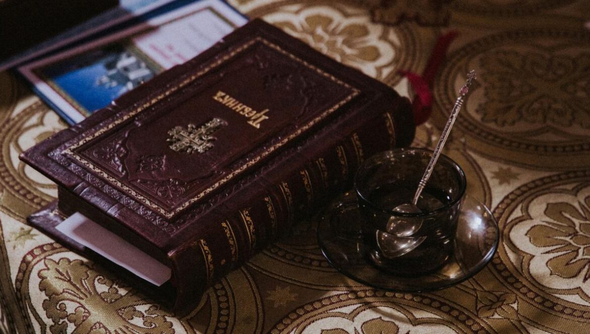 photo of beige and maroon bible