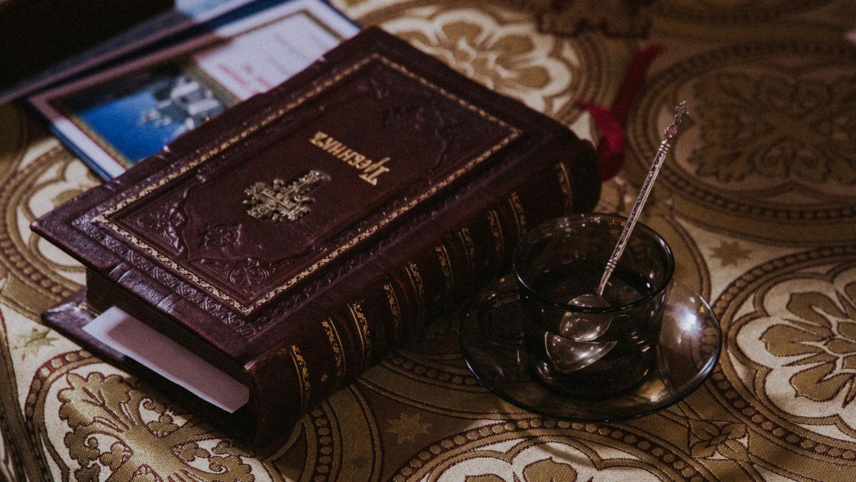 photo of beige and maroon bible