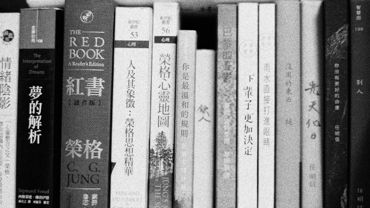 white and black book on white wooden shelf