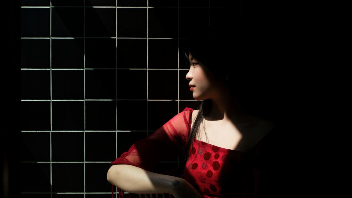 woman in red and black long sleeve shirt sitting on chair