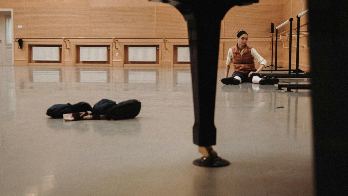 man sitting on floor inside well-lit room