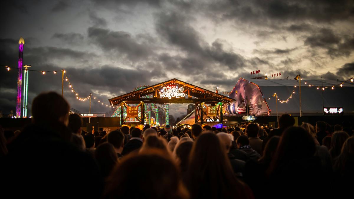 people standing beside brown stage during night time