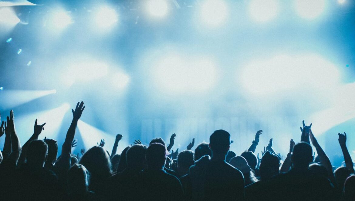 a group of people with their hands up in the air