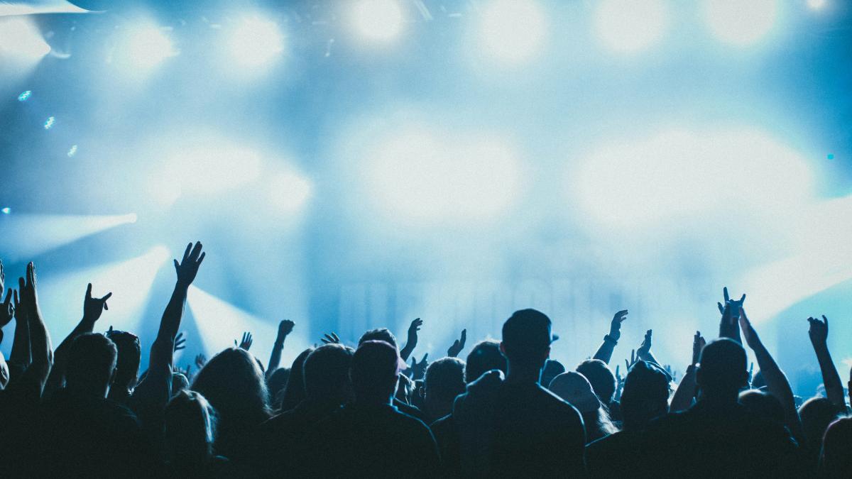 a group of people with their hands up in the air
