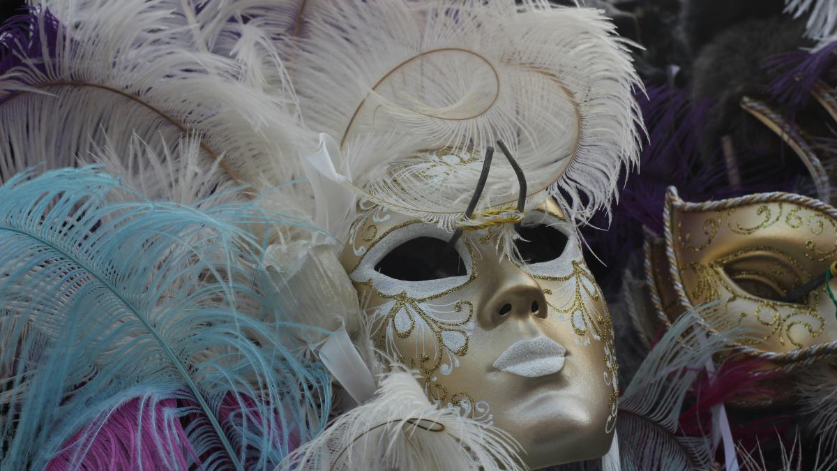 white and purple feather mask