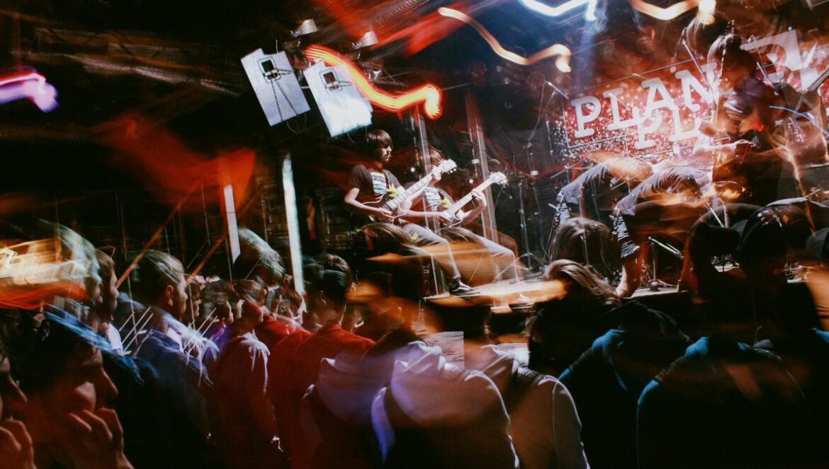 people standing on stage during night time