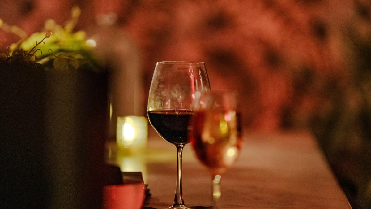 A couple of glasses of wine sitting on top of a table