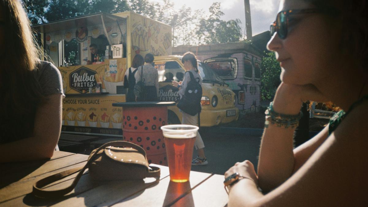 woman in black sunglasses sitting beside table