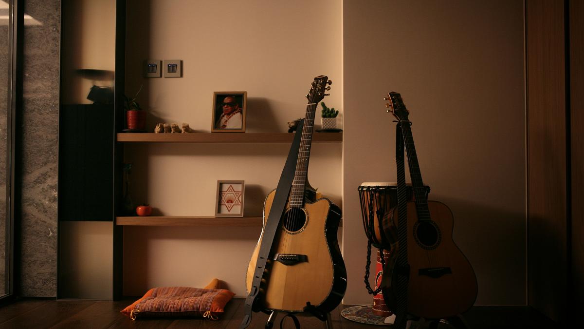 brown and black acoustic guitars on black steel stand
