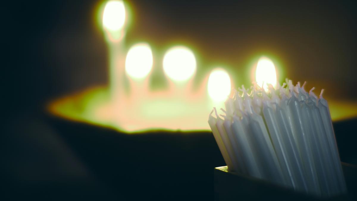 a group of white candles sitting on top of a table