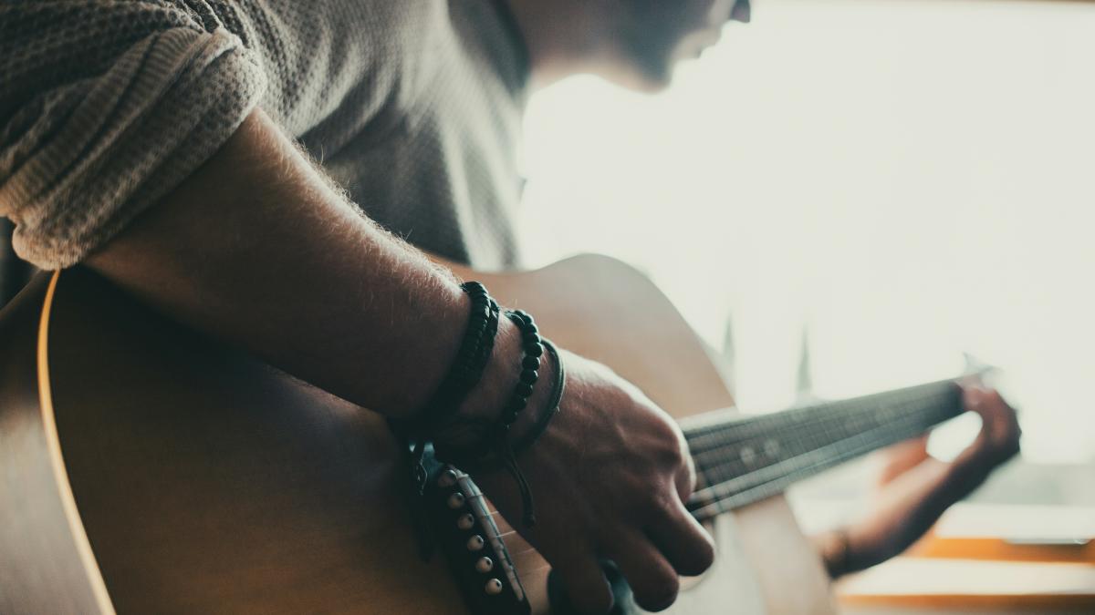 man playing guitar inside room