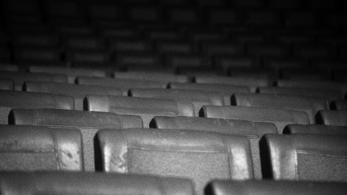 A black and white photo of a row of empty seats