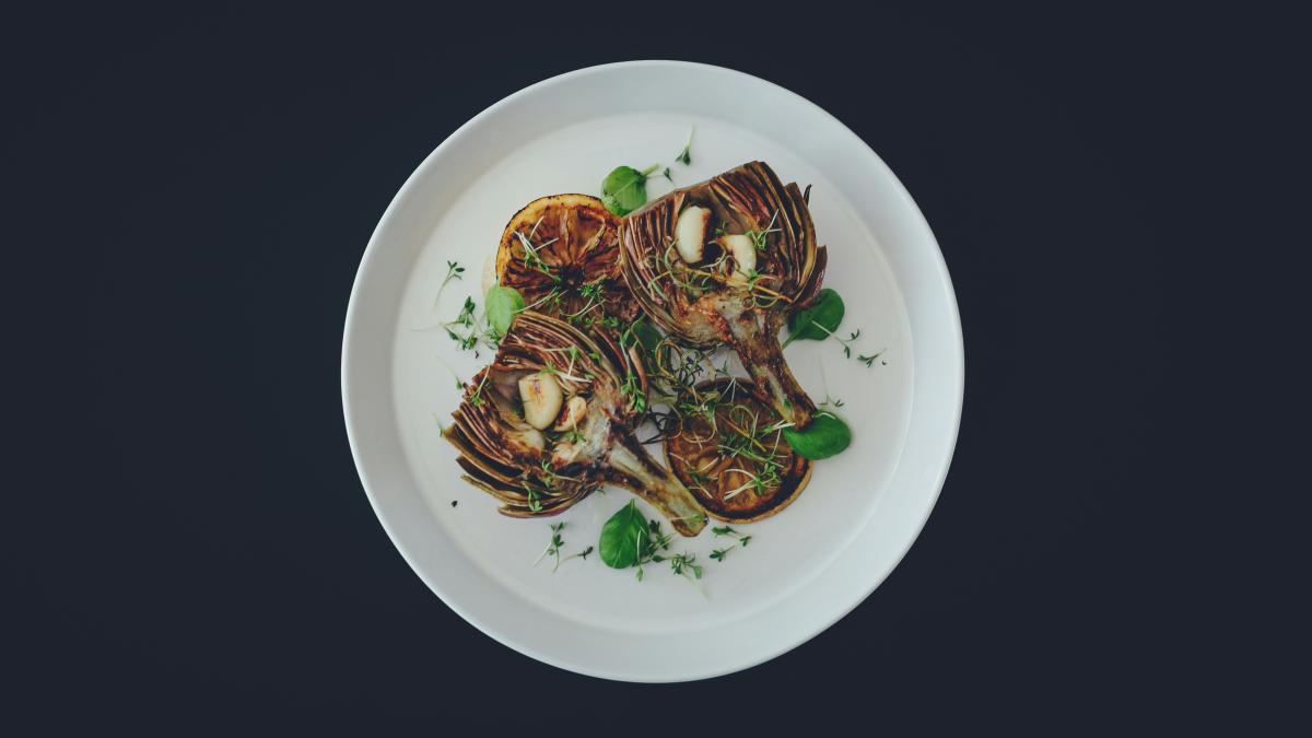 filled round white plate on black surface