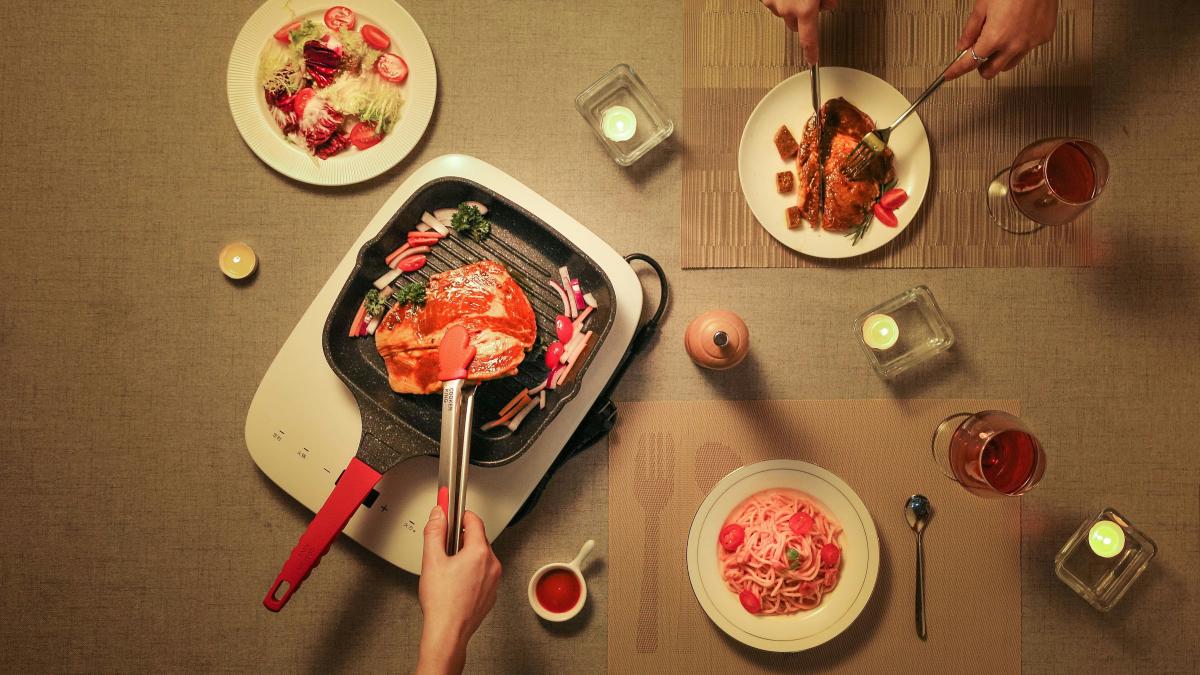 person slicing raw meat on white ceramic plate