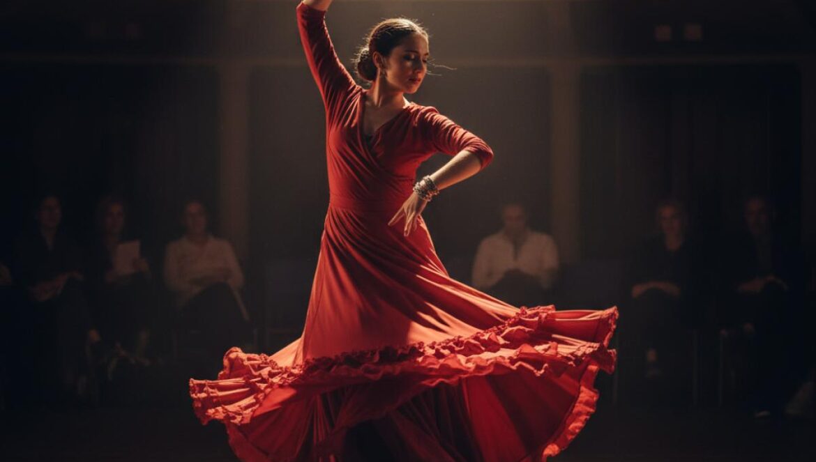 Bailaora de flamenco con vestido rojo actuando con pasión bajo un foco en un escenario moderno y oscuro.